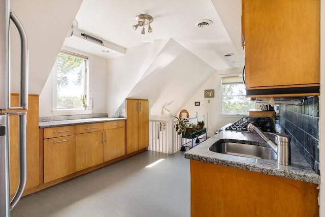 112 School Unit 3, Boston, MA 02119 - kitchen with a sink, brown cabinetry, stone countertops, and lofted ceiling