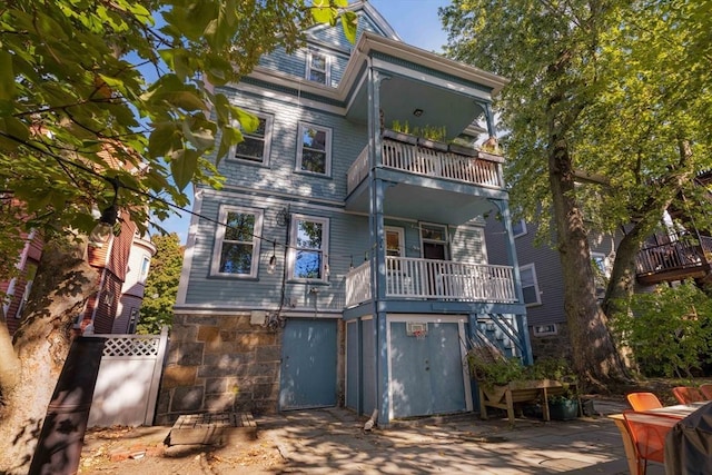 112 School Unit 3, Boston, MA 02119 - rear view of house featuring a balcony and stairway