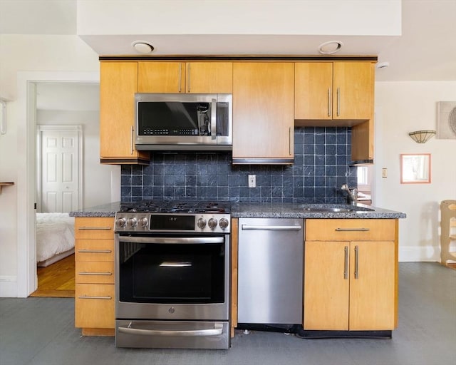 112 School Unit 3, Boston, MA 02119 - kitchen featuring stainless steel appliances, decorative backsplash, baseboards, and dark stone countertops