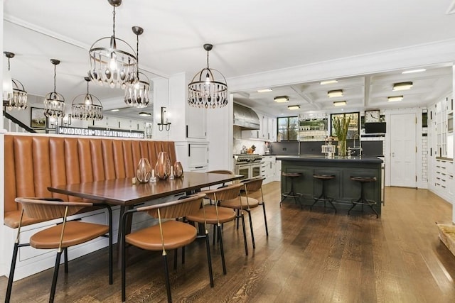 dining room with ornamental molding, dark wood-type flooring, beamed ceiling, and coffered ceiling