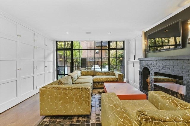 interior space with expansive windows, a brick fireplace, and plenty of natural light