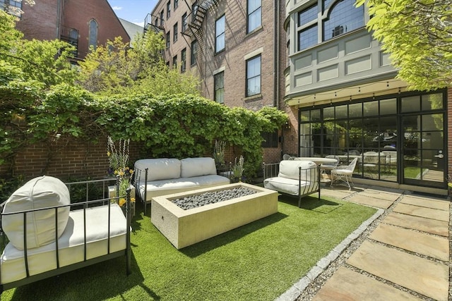 surrounding community featuring a patio and an outdoor fire pit