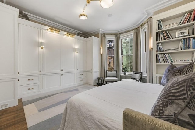 bedroom featuring ornamental molding and light wood-style flooring