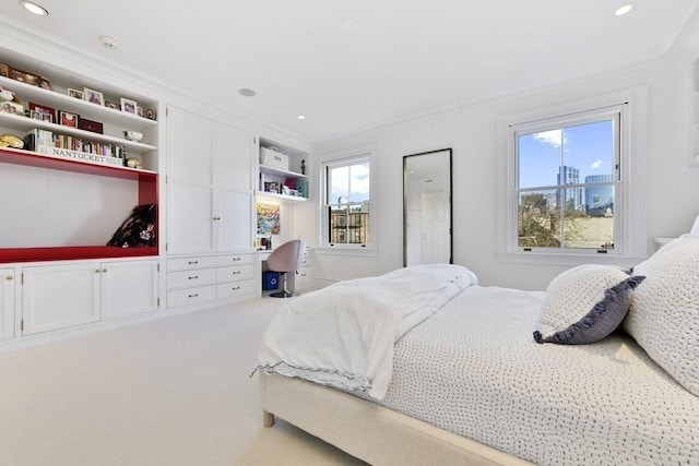 carpeted bedroom with recessed lighting, ornamental molding, and built in study area