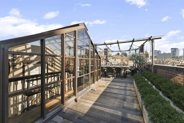 wooden terrace featuring a view of city