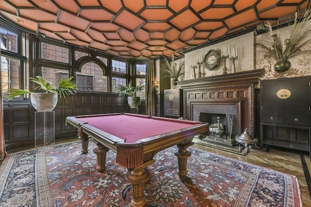 playroom with coffered ceiling, a fireplace with raised hearth, and pool table