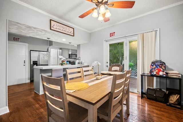 dining room with dark wood-type flooring, ceiling fan, ornamental molding, and a textured ceiling