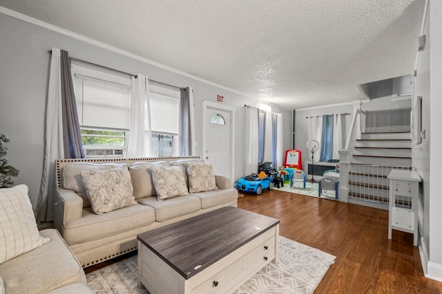 living room featuring ornamental molding, dark hardwood / wood-style flooring, and a textured ceiling