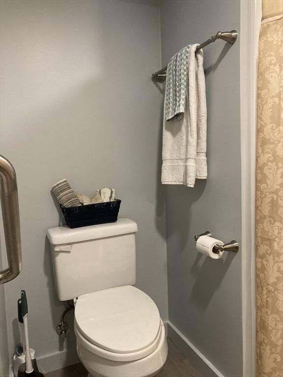 bathroom with hardwood / wood-style floors and toilet