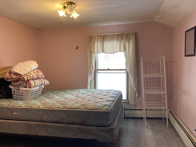 bedroom featuring a baseboard radiator, lofted ceiling, and wood-type flooring