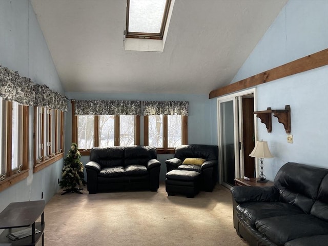 living room featuring high vaulted ceiling, a skylight, and carpet floors