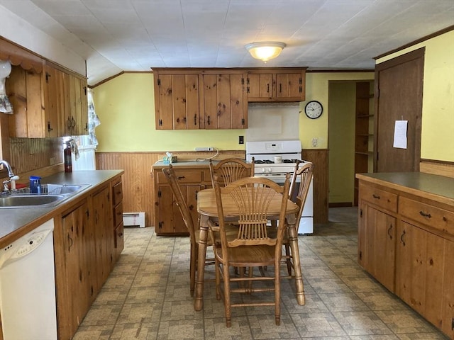 kitchen featuring sink, ornamental molding, wooden walls, white appliances, and a baseboard heating unit