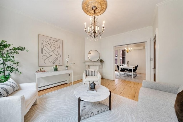 living area featuring crown molding, a notable chandelier, light wood finished floors, baseboard heating, and baseboards