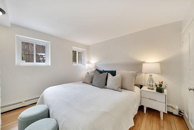 bedroom featuring a baseboard radiator and wood finished floors