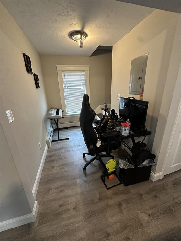 21 Sigel St, Worcester, MA 01610 - home office featuring electric panel, baseboards, a baseboard radiator, and wood finished floors