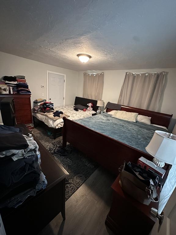 21 Sigel St, Worcester, MA 01610 - bedroom with wood finished floors and a textured ceiling