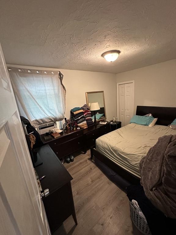 21 Sigel St, Worcester, MA 01610 - bedroom with wood finished floors and a textured ceiling