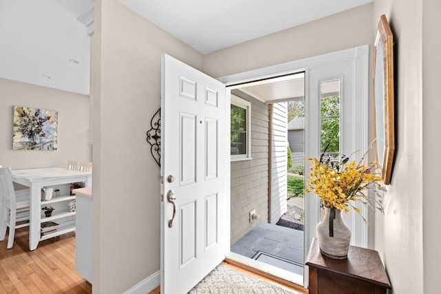 entrance foyer with light wood-style floors and baseboards