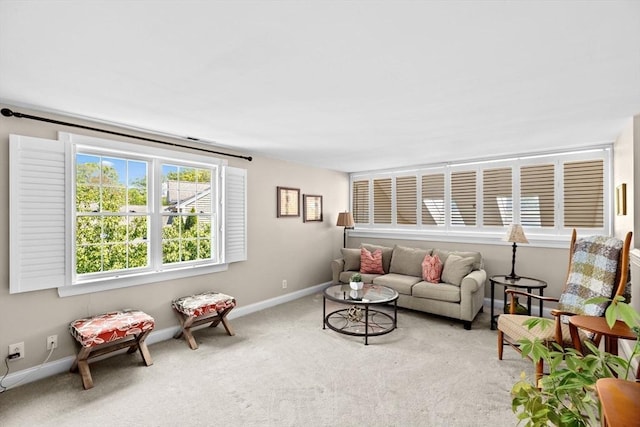 carpeted living room featuring baseboards