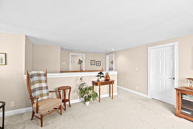 sitting room featuring carpet flooring and baseboards