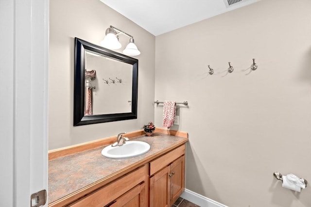 bathroom with vanity and baseboards