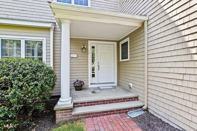 view of exterior entry with a porch