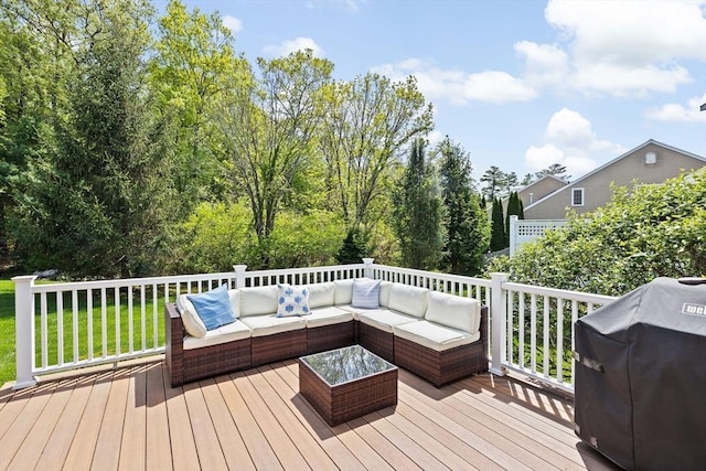 wooden deck featuring outdoor lounge area, grilling area, and a yard