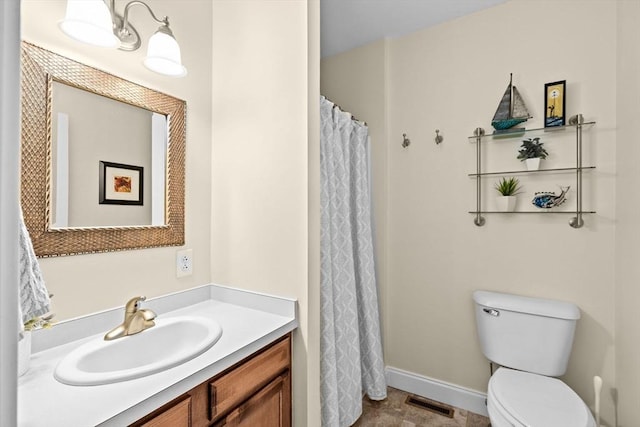 bathroom featuring toilet, vanity, baseboards, and curtained shower