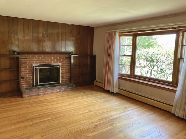 68 Briarbrook Dr, Seekonk, MA 02771 - unfurnished living room featuring light wood-style flooring, wooden walls, a fireplace, and a baseboard radiator