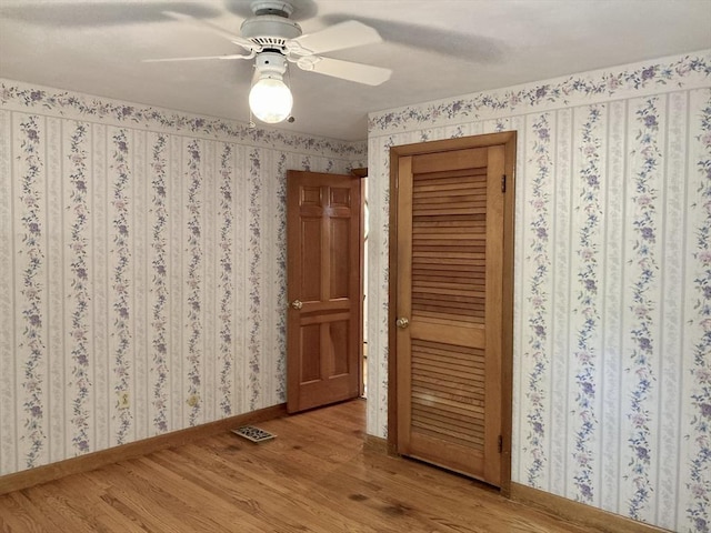 68 Briarbrook Dr, Seekonk, MA 02771 - empty room featuring light wood-style floors, baseboards, a ceiling fan, and wallpapered walls