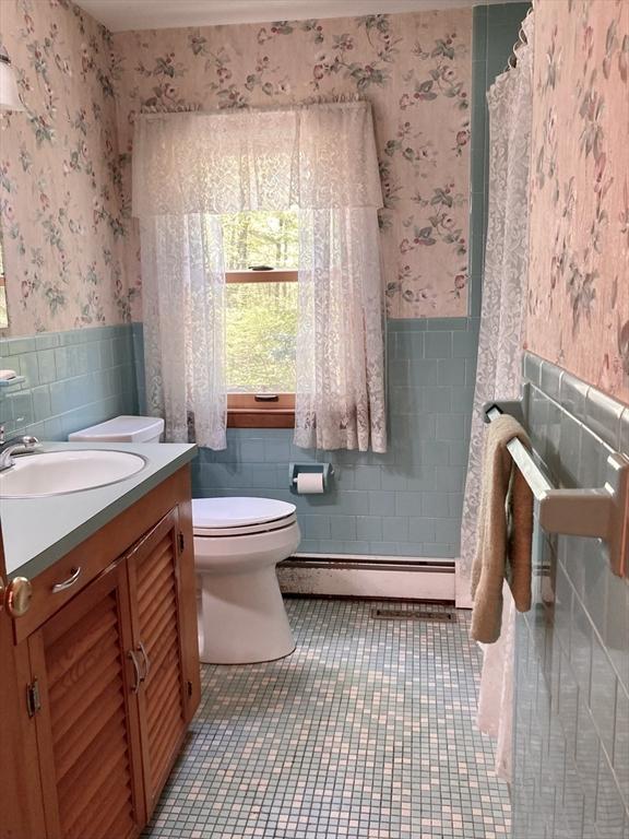 68 Briarbrook Dr, Seekonk, MA 02771 - full bathroom with tile walls, wallpapered walls, a wainscoted wall, baseboard heating, and tile patterned floors
