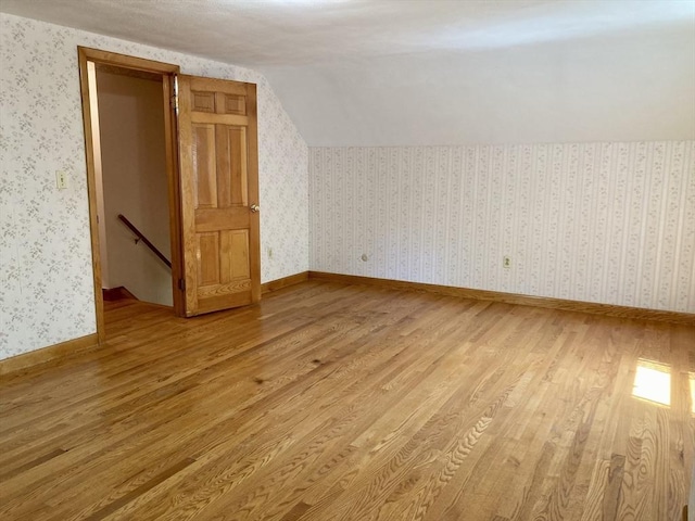 68 Briarbrook Dr, Seekonk, MA 02771 - bonus room featuring light wood finished floors, vaulted ceiling, wallpapered walls, and baseboards