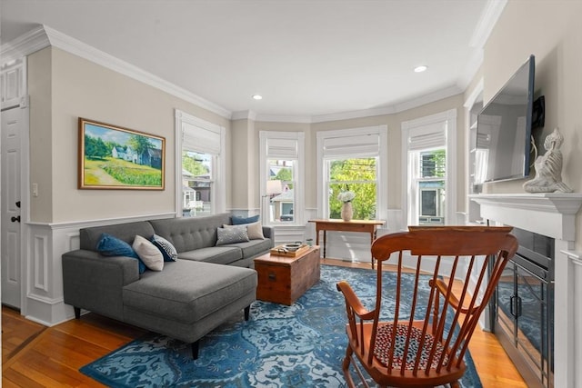 4 Arlington St Unit A, Newburyport, MA 01950 - living area with light wood-style floors, crown molding, healthy amount of natural light, a fireplace, and wainscoting