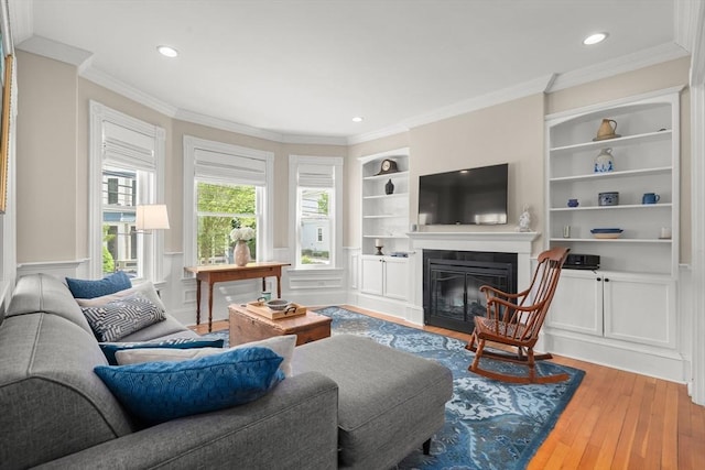 4 Arlington St Unit A, Newburyport, MA 01950 - living area with a glass covered fireplace, built in shelves, ornamental molding, wood finished floors, and recessed lighting