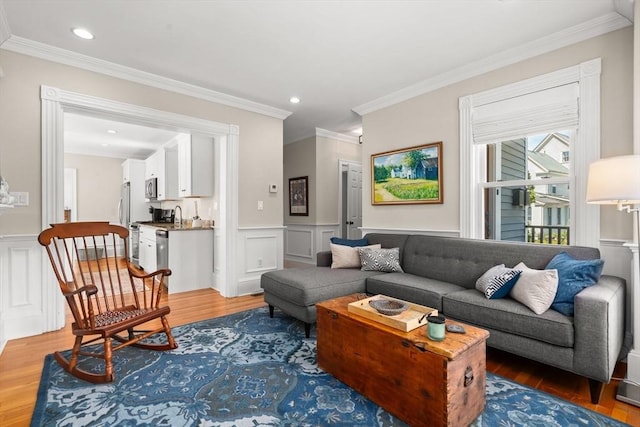 4 Arlington St Unit A, Newburyport, MA 01950 - living room featuring wood finished floors, ornamental molding, wainscoting, a decorative wall, and recessed lighting