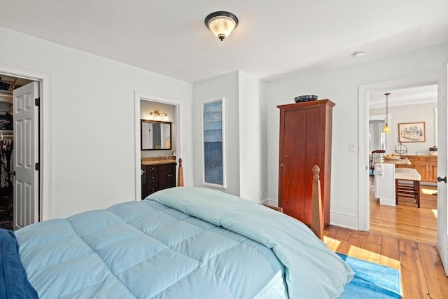 4 Arlington St Unit A, Newburyport, MA 01950 - bedroom with light wood-style flooring, ensuite bathroom, a spacious closet, and baseboards