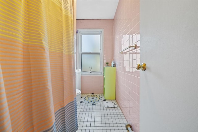 full bathroom with toilet, tile walls, and tile patterned floors