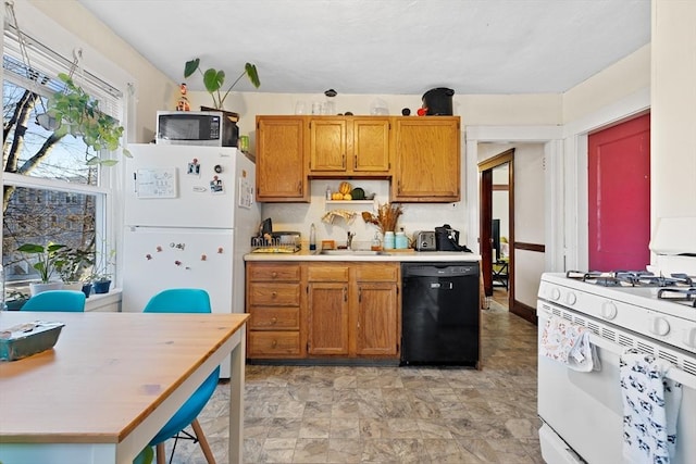 kitchen featuring white appliances, brown cabinetry, light countertops, open shelves, and a sink