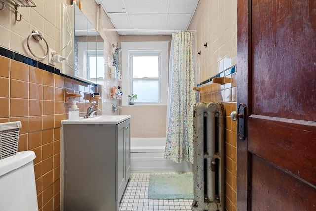 bathroom featuring vanity, tile walls, toilet, and tile patterned floors