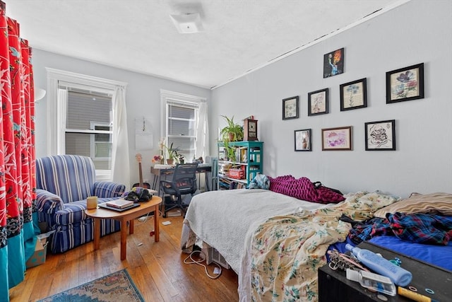 bedroom with hardwood / wood-style floors