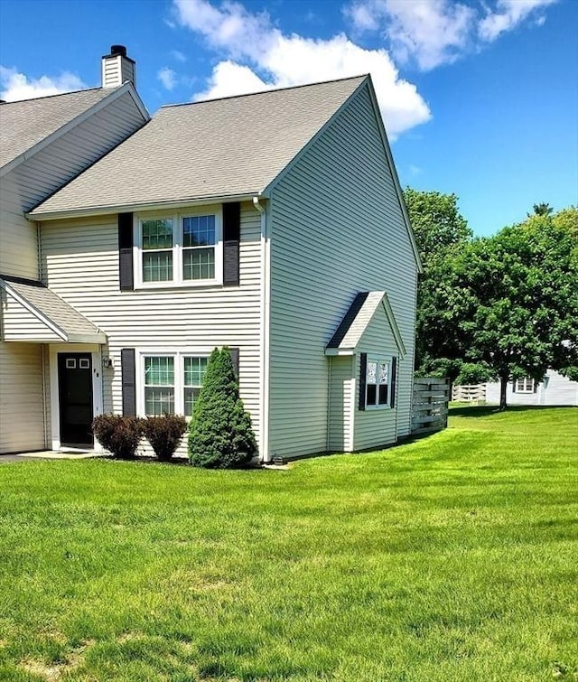 728 Auburn St Unit F8, Whitman, MA 02382 - view of side of home with a chimney, a lawn, and roof with shingles