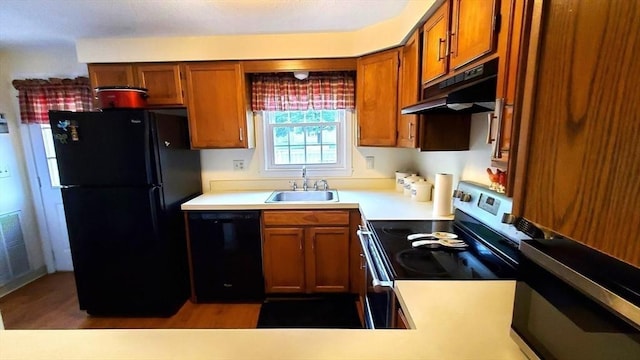 728 Auburn St Unit F8, Whitman, MA 02382 - kitchen featuring black appliances, under cabinet range hood, brown cabinetry, and light countertops