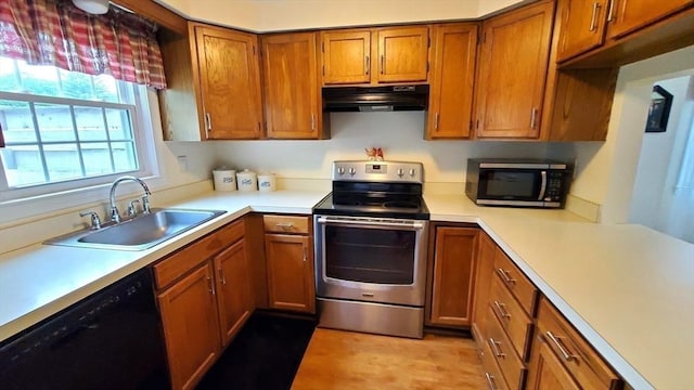 728 Auburn St Unit F8, Whitman, MA 02382 - kitchen with appliances with stainless steel finishes, under cabinet range hood, brown cabinets, and light countertops