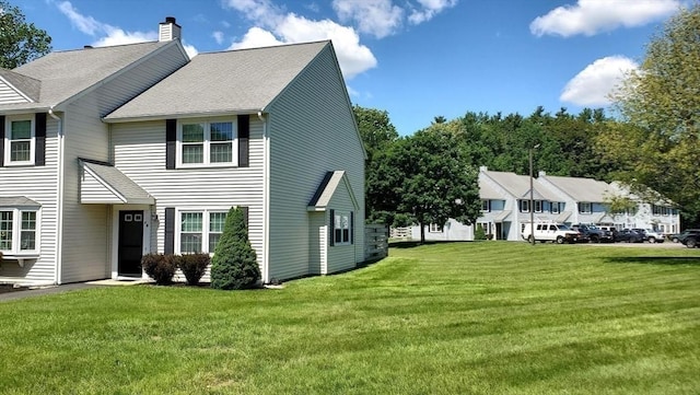728 Auburn St Unit F8, Whitman, MA 02382 - view of home's exterior featuring a yard, a chimney, and roof with shingles