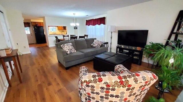 728 Auburn St Unit F8, Whitman, MA 02382 - living room with plenty of natural light, a chandelier, and wood finished floors