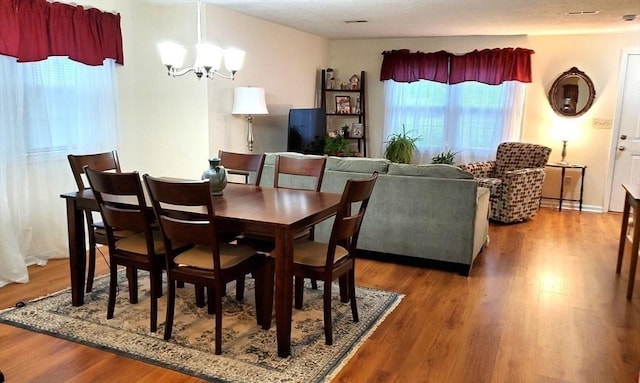 728 Auburn St Unit F8, Whitman, MA 02382 - dining area featuring a chandelier and wood finished floors