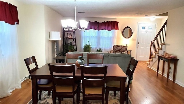 728 Auburn St Unit F8, Whitman, MA 02382 - dining room featuring a chandelier, wood finished floors, and stairs