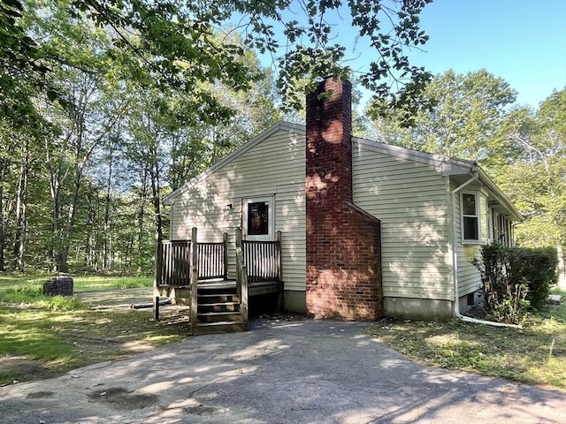 2 Bushy Ln, Rutland, MA 01543 - view of side of property with a chimney and a wooden deck