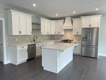 288 Fisher Rd, Holden, MA 01520 - kitchen featuring appliances with stainless steel finishes, premium range hood, light countertops, a center island, and recessed lighting