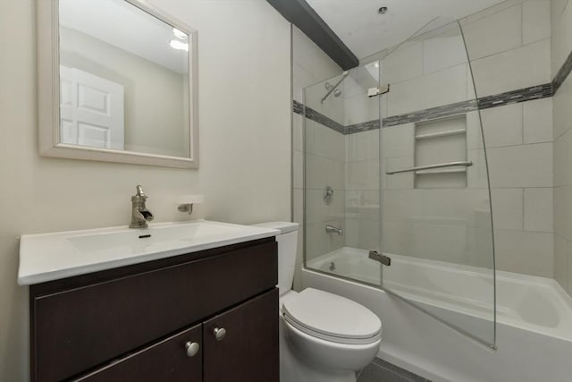 full bathroom featuring toilet, combined bath / shower with glass door, and vanity